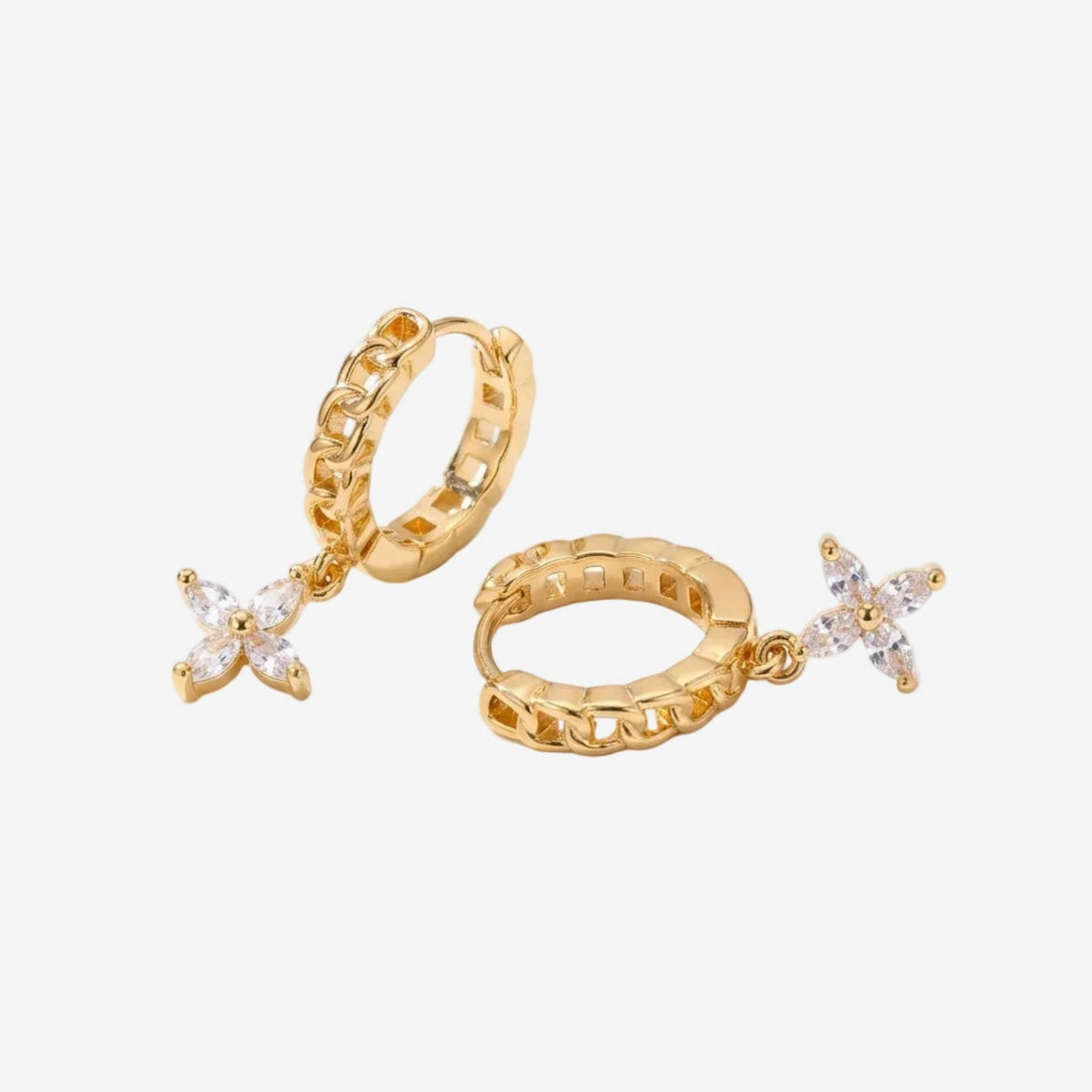 Gold hoop earrings with star-shaped gemstones on a white background