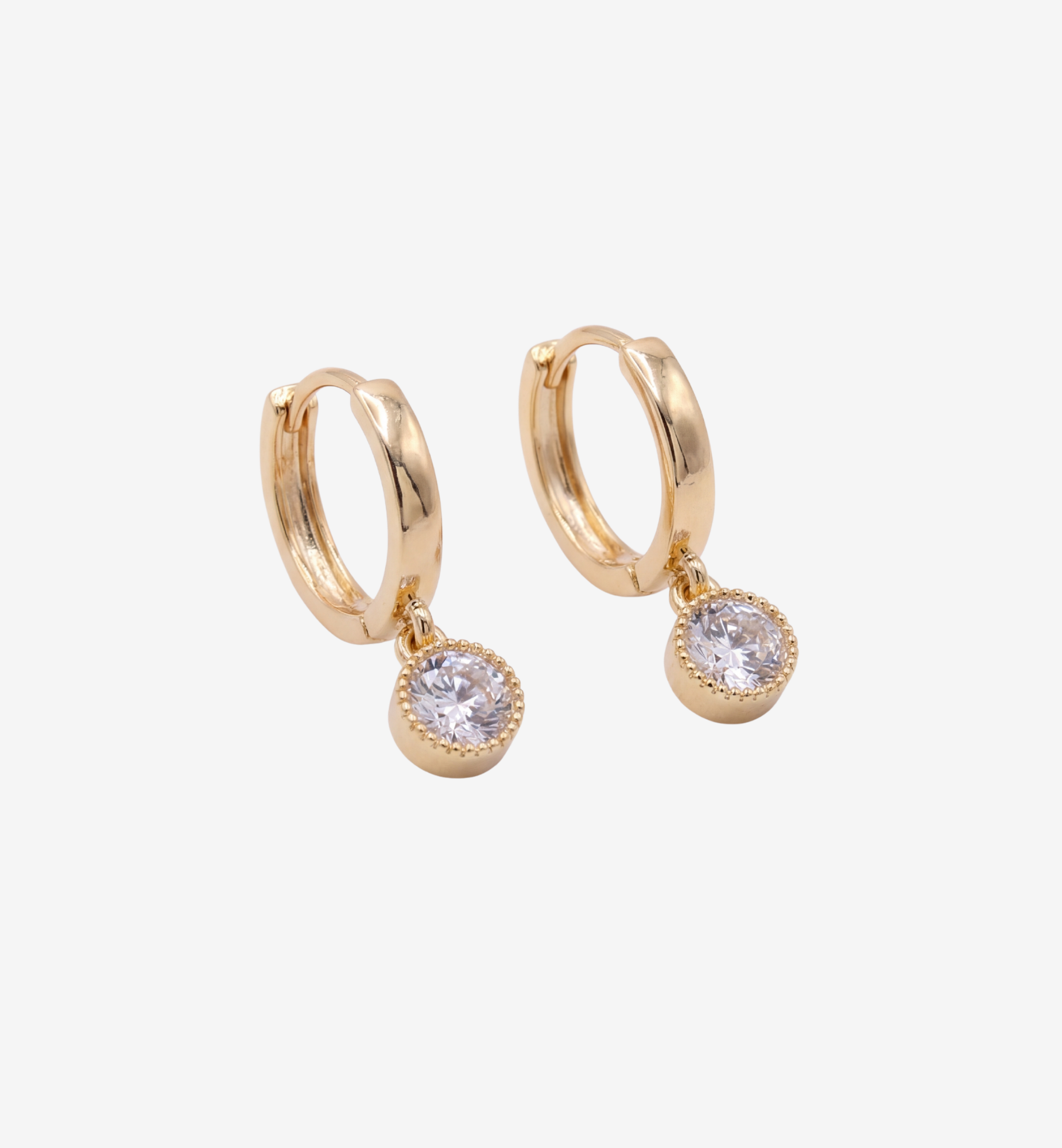 Gold hoop earrings with round gemstones on a white background