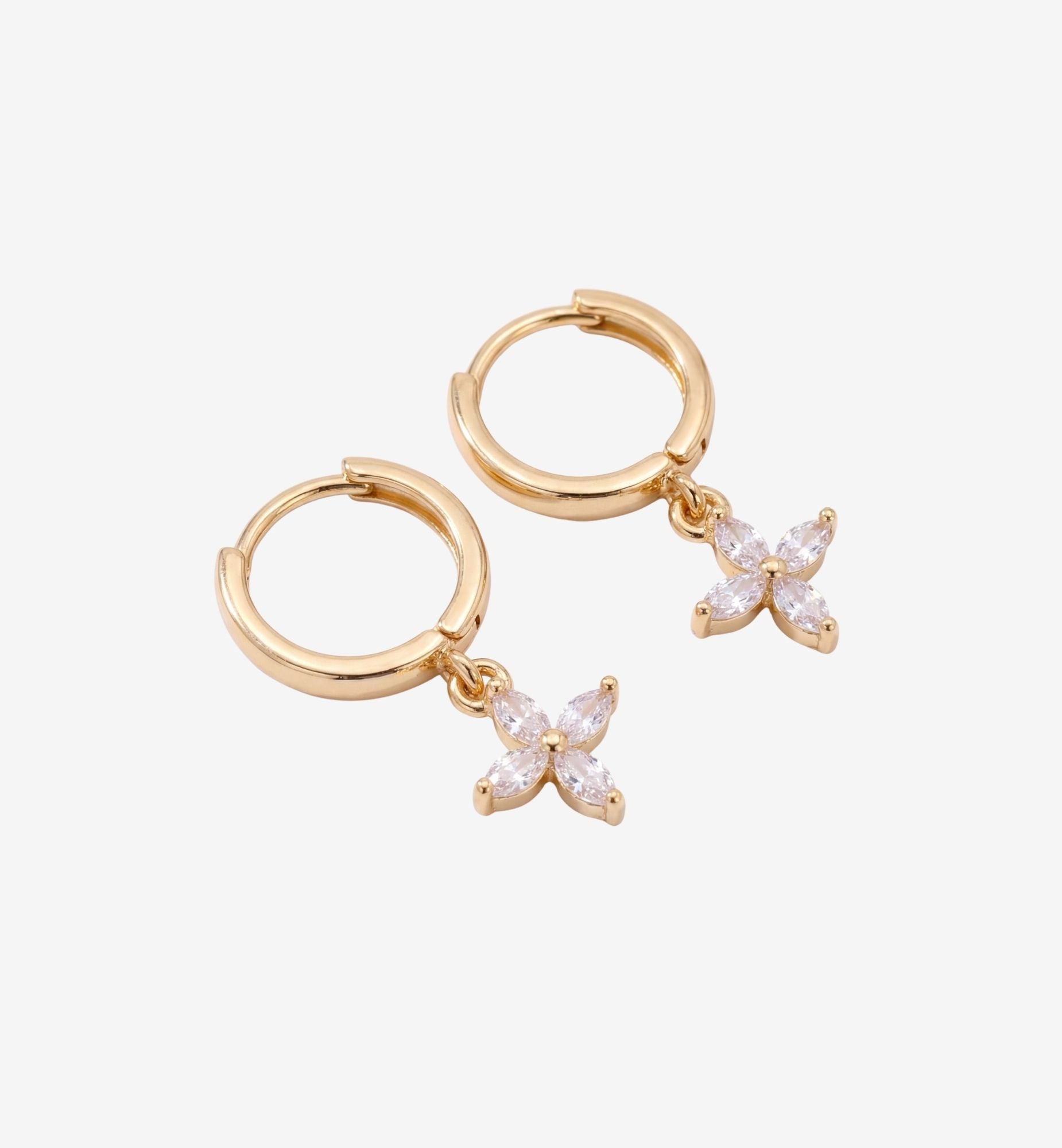 Gold hoop earrings with butterfly-shaped charms on a white background