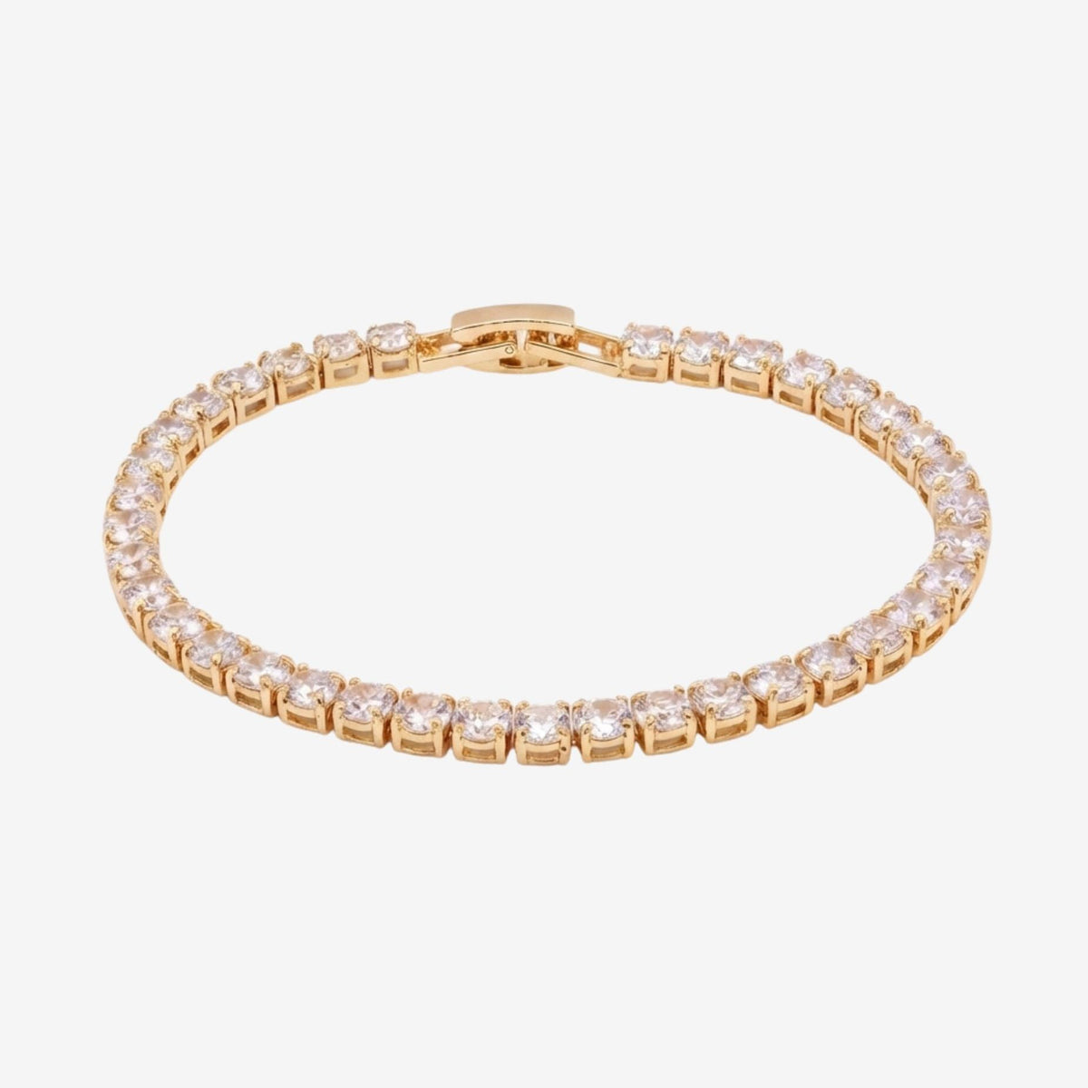 Gold bracelet with clear stones on a white background