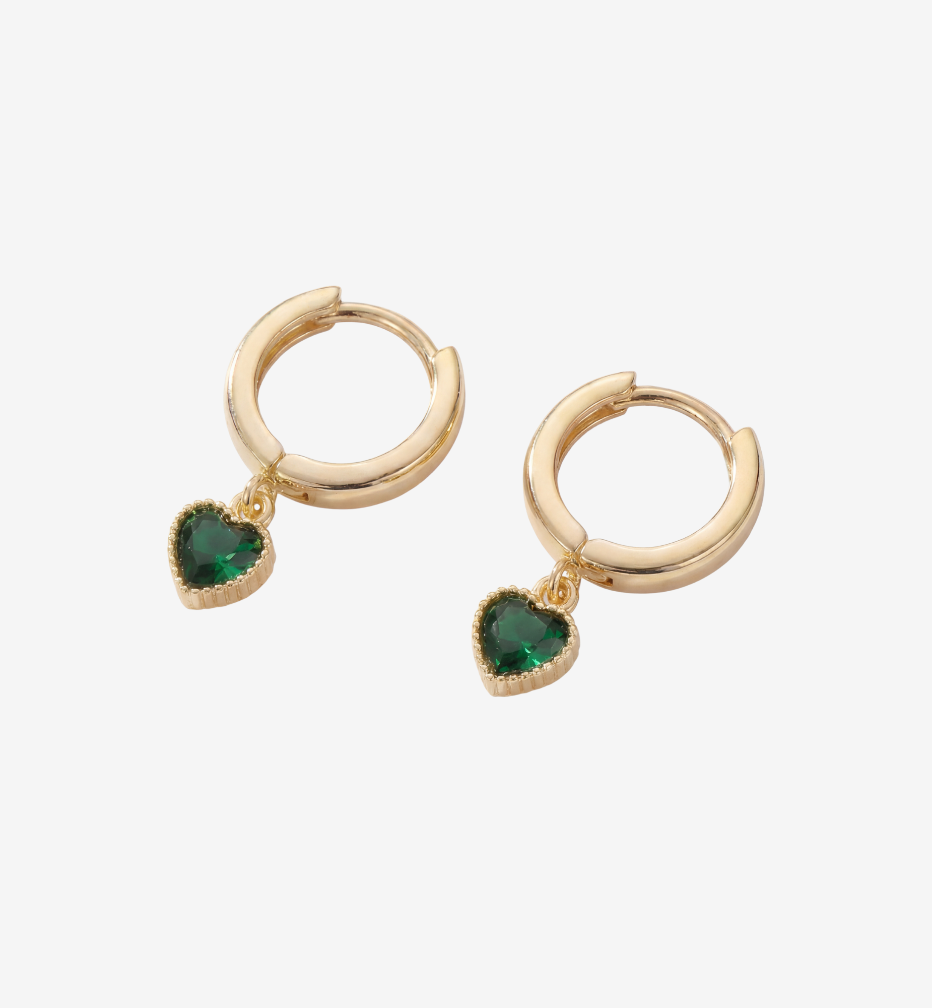 Gold hoop earrings with green heart-shaped stones on a white background